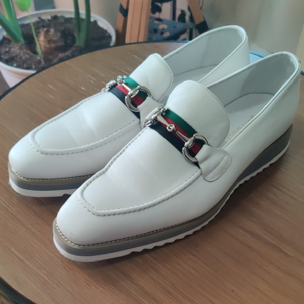 White Carrucci Slip-On Loafers with Textured Leather and Decorative Strap.